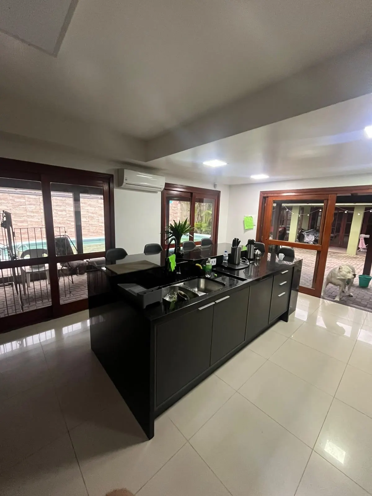 Depois – Cozinha reconstruída, com ilha ampla e marcenaria em grafite, Sobrado pós-enchente (Canoas/RS)
